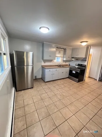 a kitchen with a sink and refrigerator