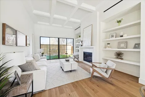 a living room with furniture fireplace and window