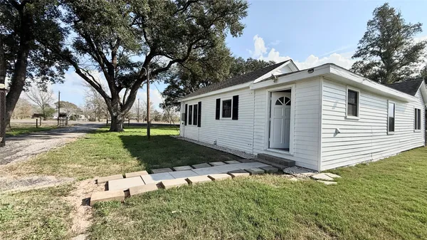 a view of a white house with a yard