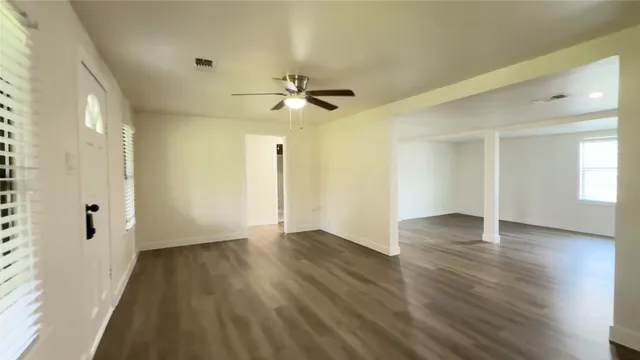 wooden floor in an empty room with a window