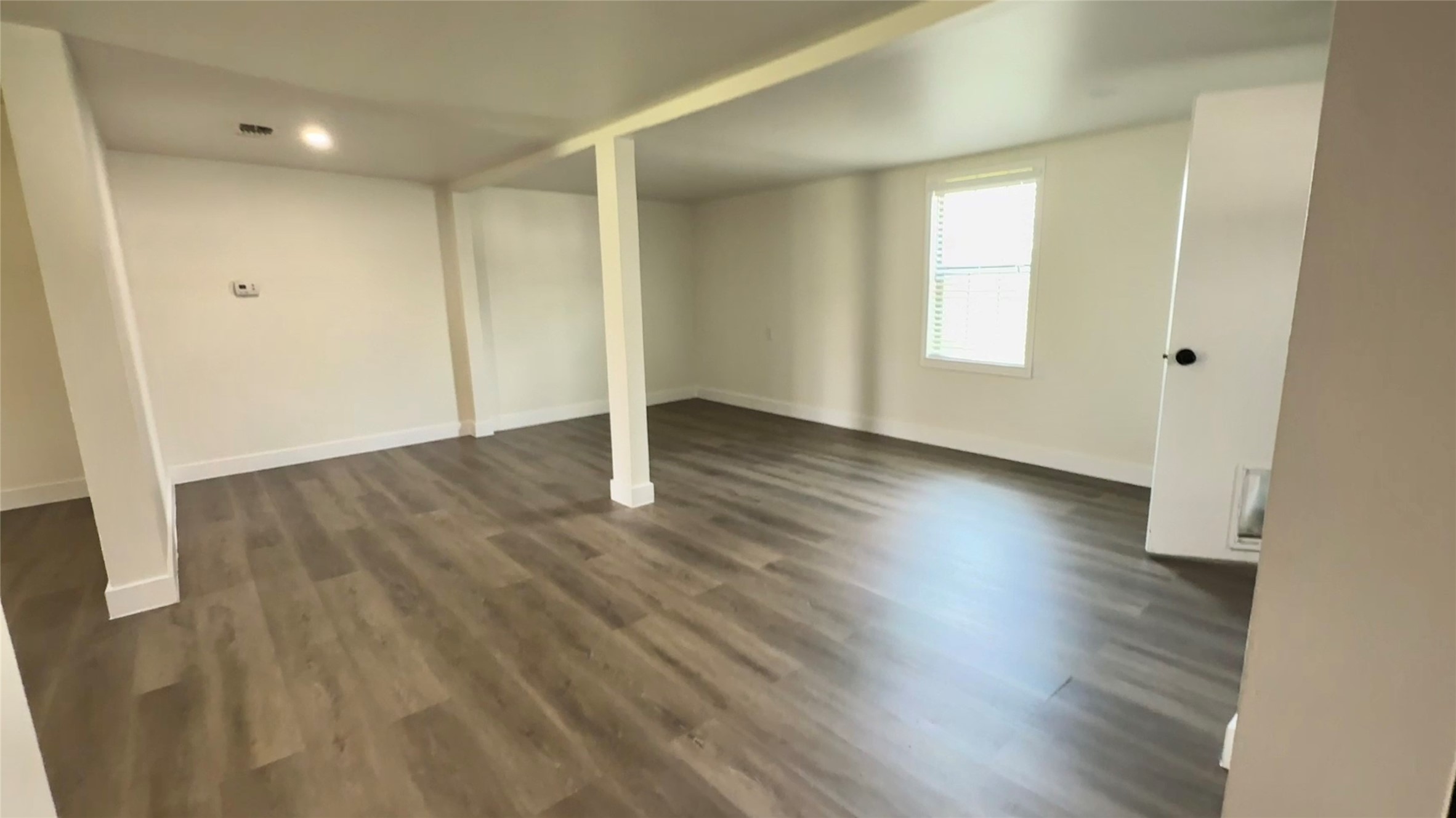 13309 Farm To Market 359 Hempstead, TX 77445 - Photo 17 of 34 an empty room with wooden floor and windows