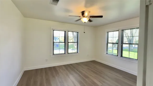 wooden floor in an empty room with a window