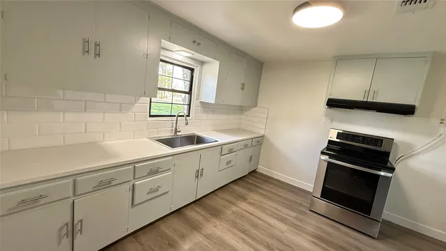 a kitchen with sink cabinets and appliances