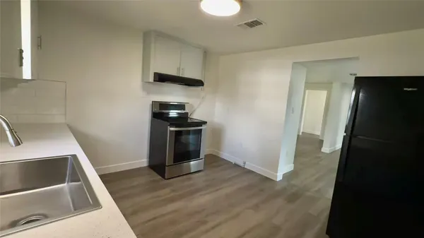 a kitchen with a sink a stove and refrigerator