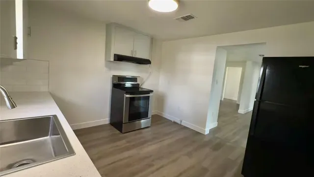 a kitchen with a sink a stove and refrigerator