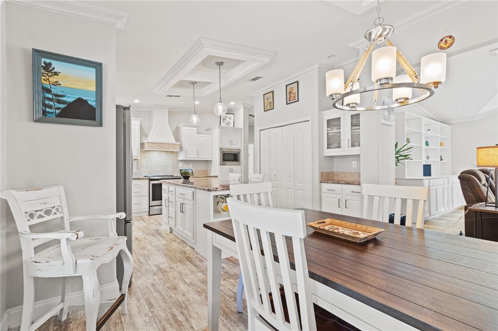 9410 Southwest 156th Place Dunnellon, FL 34432 - Photo 15 of 56 a view of a dining room with furniture a chandelier and wooden floor