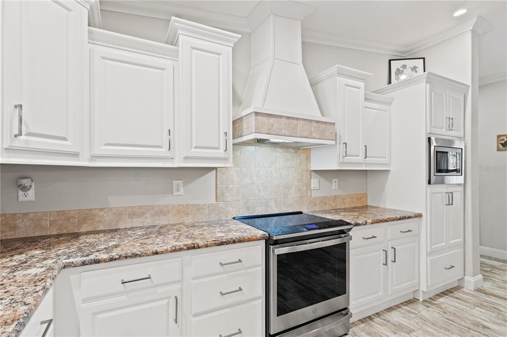 9410 Southwest 156th Place Dunnellon, FL 34432 - Photo 18 of 56 a kitchen with stainless steel appliances granite countertop white cabinets and a granite counter tops