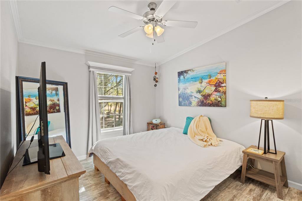 9410 Southwest 156th Place Dunnellon, FL 34432 - Photo 24 of 56 a bedroom with a bed and a chandelier