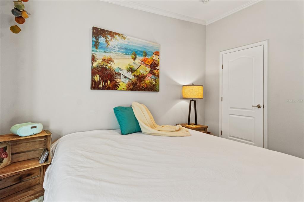 9410 Southwest 156th Place Dunnellon, FL 34432 - Photo 25 of 56 a bedroom with a bed a painting on the wall and a lamp