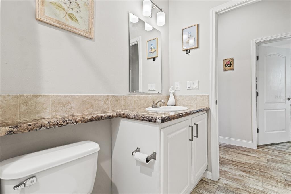 9410 Southwest 156th Place Dunnellon, FL 34432 - Photo 26 of 56 a bathroom with a granite countertop sink a toilet and a shower