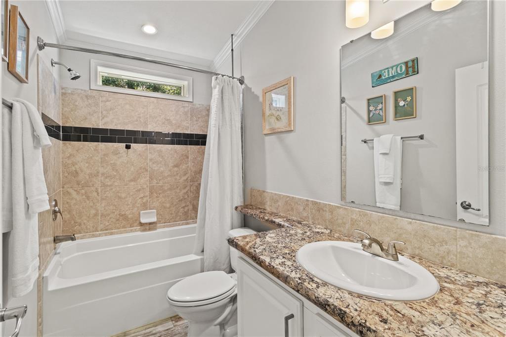 9410 Southwest 156th Place Dunnellon, FL 34432 - Photo 27 of 56 a bathroom with a granite countertop sink toilet and shower