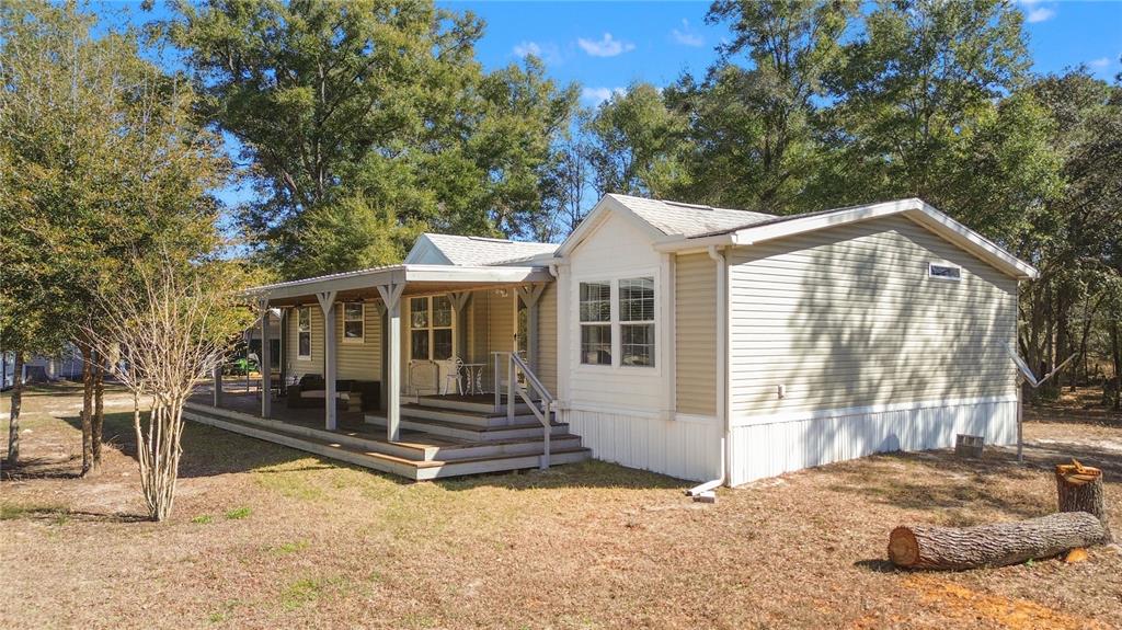 9410 Southwest 156th Place Dunnellon, FL 34432 - Photo 40 of 56 a view of a house with a yard and wooden fence