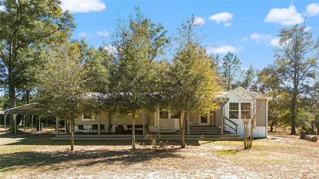 a view of a house with a yard covered in snow