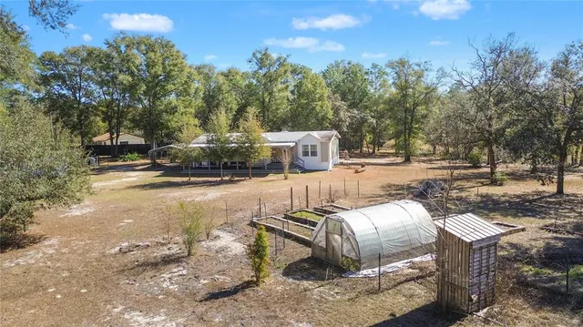 a backyard of a house with lots of green space