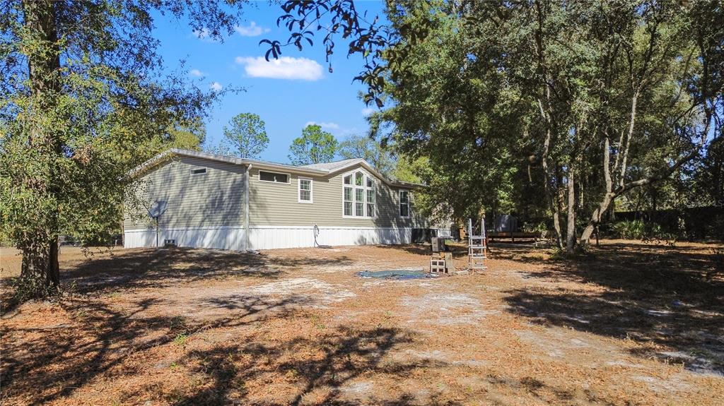 9410 Southwest 156th Place Dunnellon, FL 34432 - Photo 42 of 56 a backyard of a house with table and chairs
