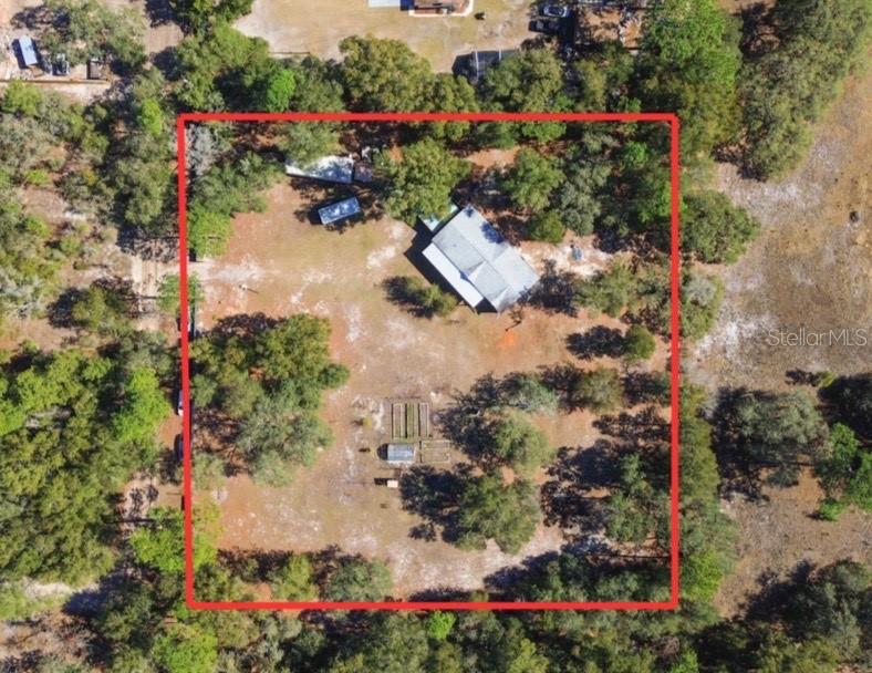 9410 Southwest 156th Place Dunnellon, FL 34432 - Photo 45 of 56 an aerial view of a house with a yard and garden