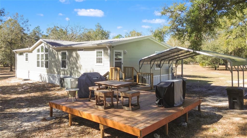 9410 Southwest 156th Place Dunnellon, FL 34432 - Photo 5 of 56 a roof deck with table and chairs and potted plants