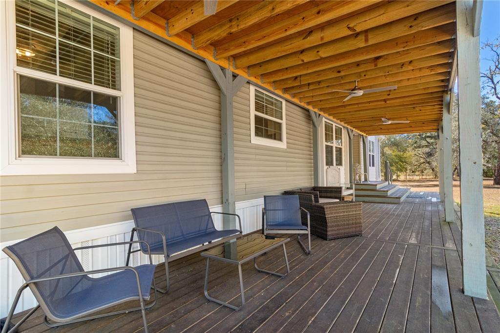 9410 Southwest 156th Place Dunnellon, FL 34432 - Photo 8 of 56 a patio with table and chairs and potted plants
