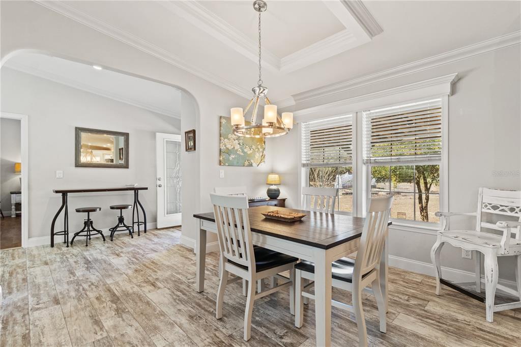 9410 Southwest 156th Place Dunnellon, FL 34432 - Photo 10 of 56 a dining room with furniture a chandelier and wooden floor