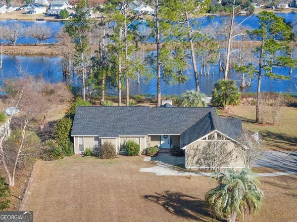 a view of a house with a yard and garage