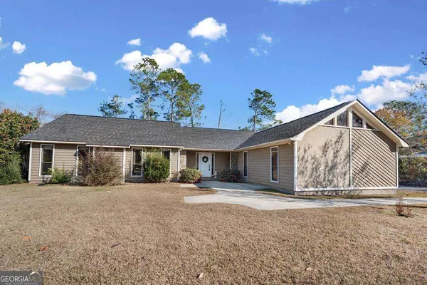 a view of a house with a yard