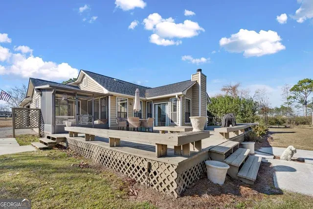 a view of a house with swimming pool and sitting area
