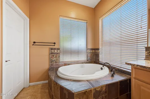 a large kitchen with stainless steel appliances kitchen island granite countertop a refrigerator and a stove top oven