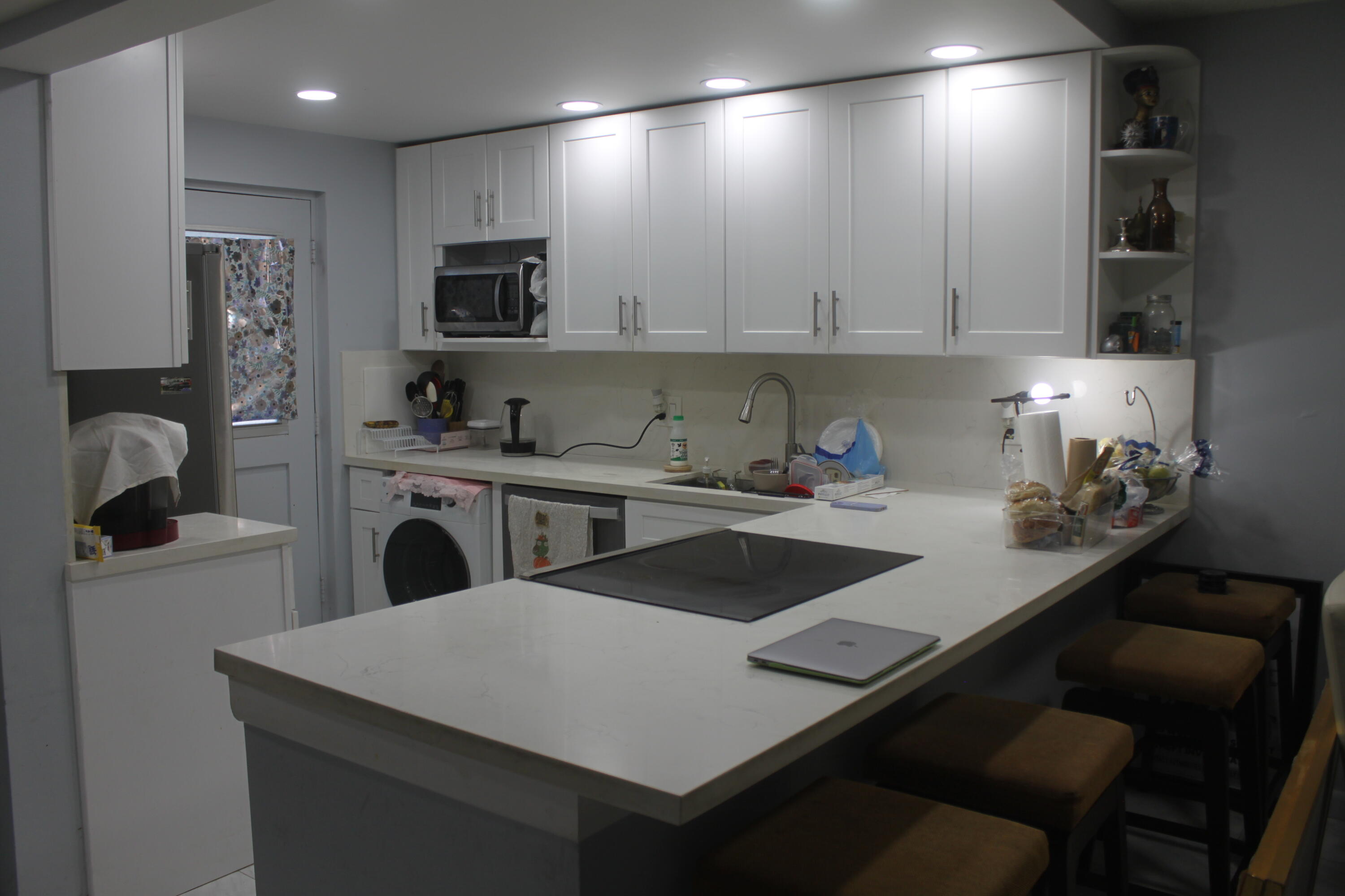 a kitchen with a sink a stove and chairs
