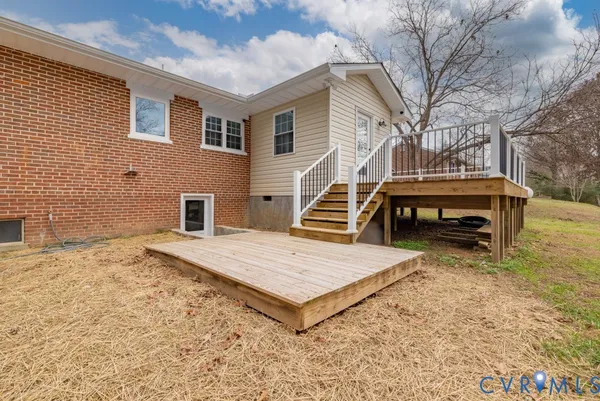 a view of a backyard with chairs and wooden fence
