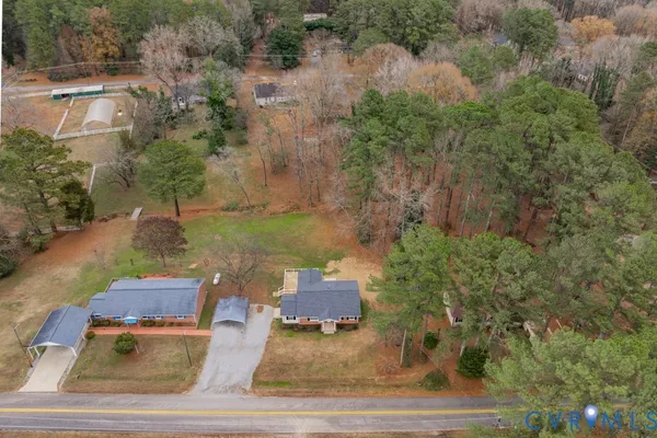 an aerial view of a house with garden space and lake view