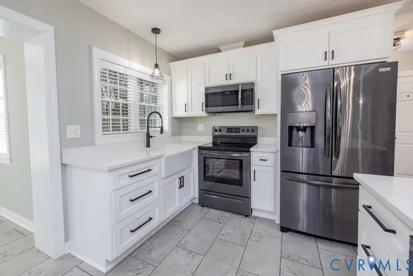 a kitchen with stainless steel appliances a refrigerator stove and microwave