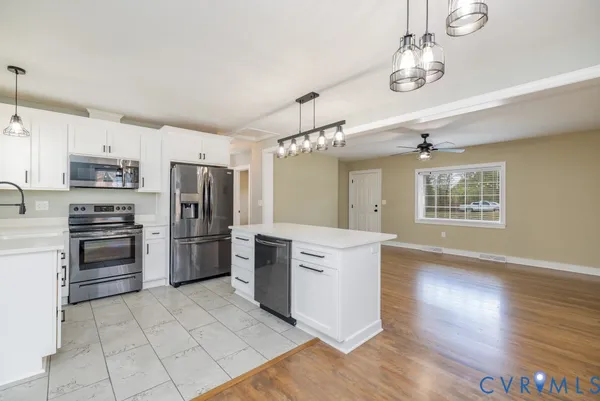 a kitchen with refrigerator cabinets and wooden floor