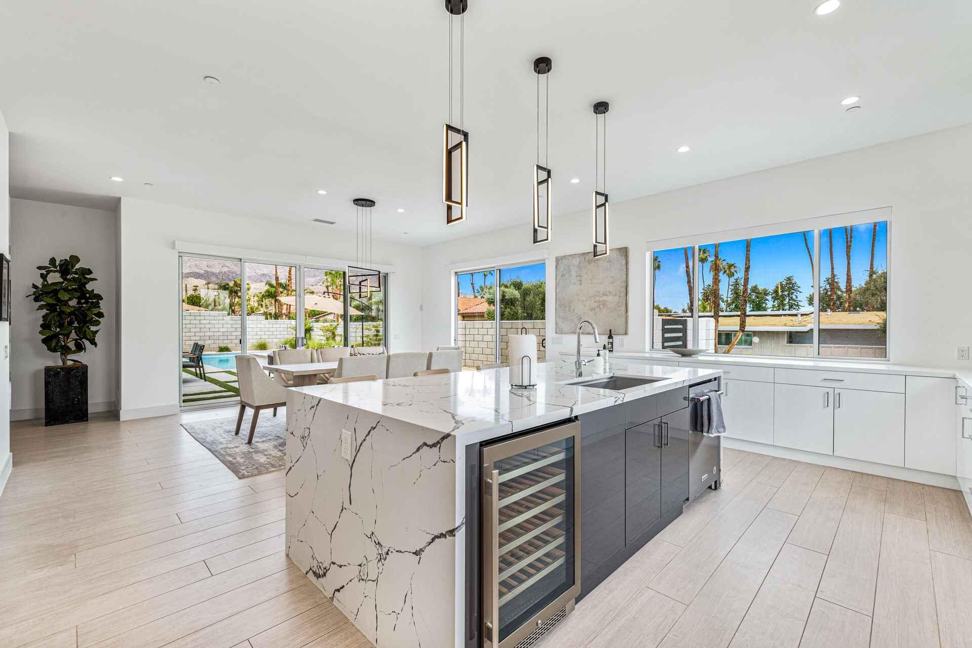 72985 Somera Road Palm Desert, CA 92260 - Photo 13 of 33 a kitchen with stainless steel appliances kitchen island granite countertop a sink and cabinets