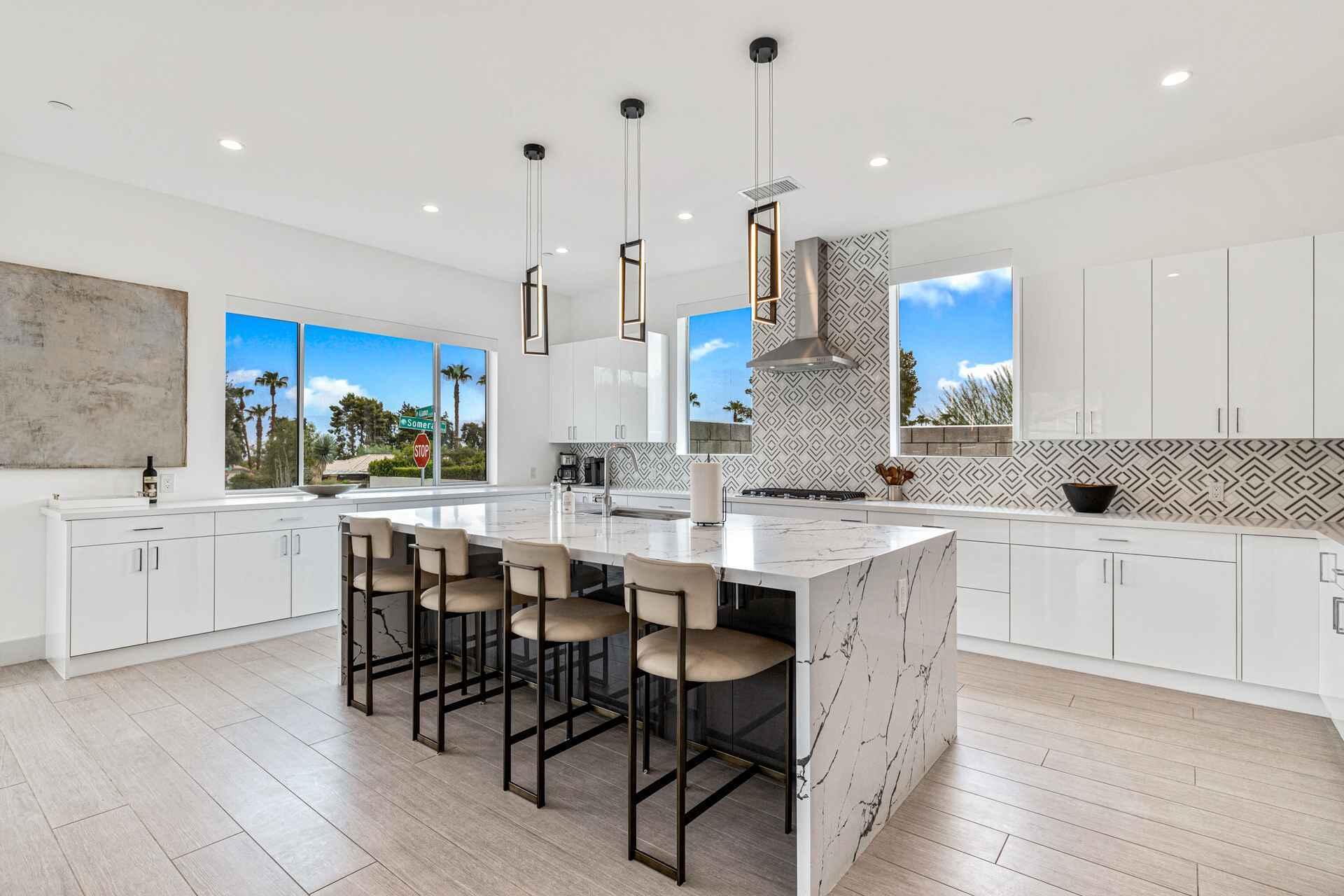 72985 Somera Road Palm Desert, CA 92260 - Photo 17 of 33 a kitchen with kitchen island granite countertop wooden cabinets and white appliances