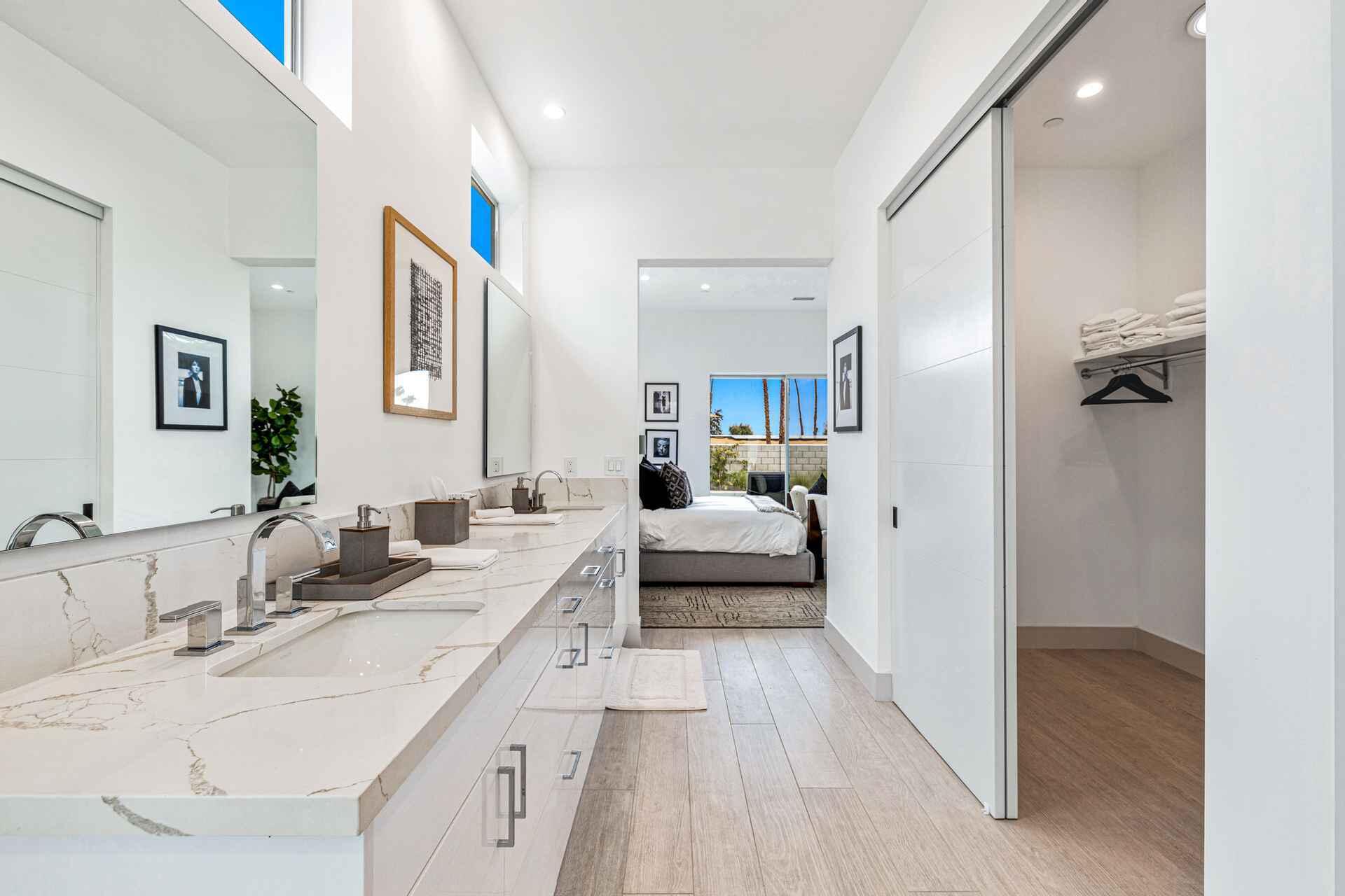 72985 Somera Road Palm Desert, CA 92260 - Photo 20 of 33 a en suite bathroom with a double vanity sink and mirror