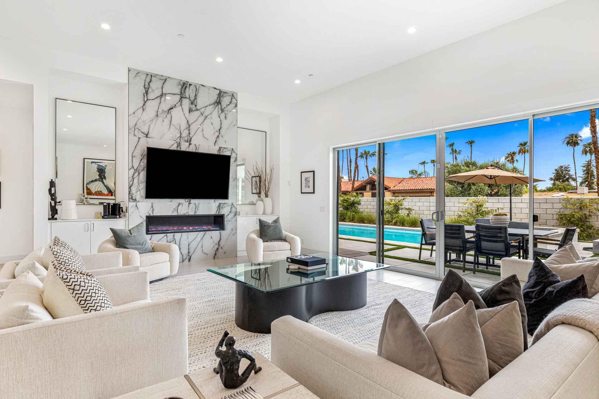 72985 Somera Road Palm Desert, CA 92260 - Photo 2 of 33 a living room with furniture and a flat screen tv