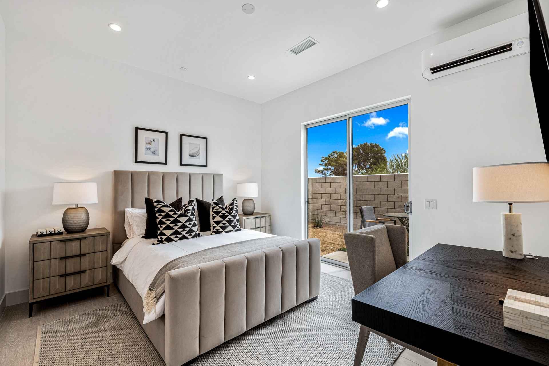 72985 Somera Road Palm Desert, CA 92260 - Photo 23 of 33 a bedroom with a bed and wooden floor