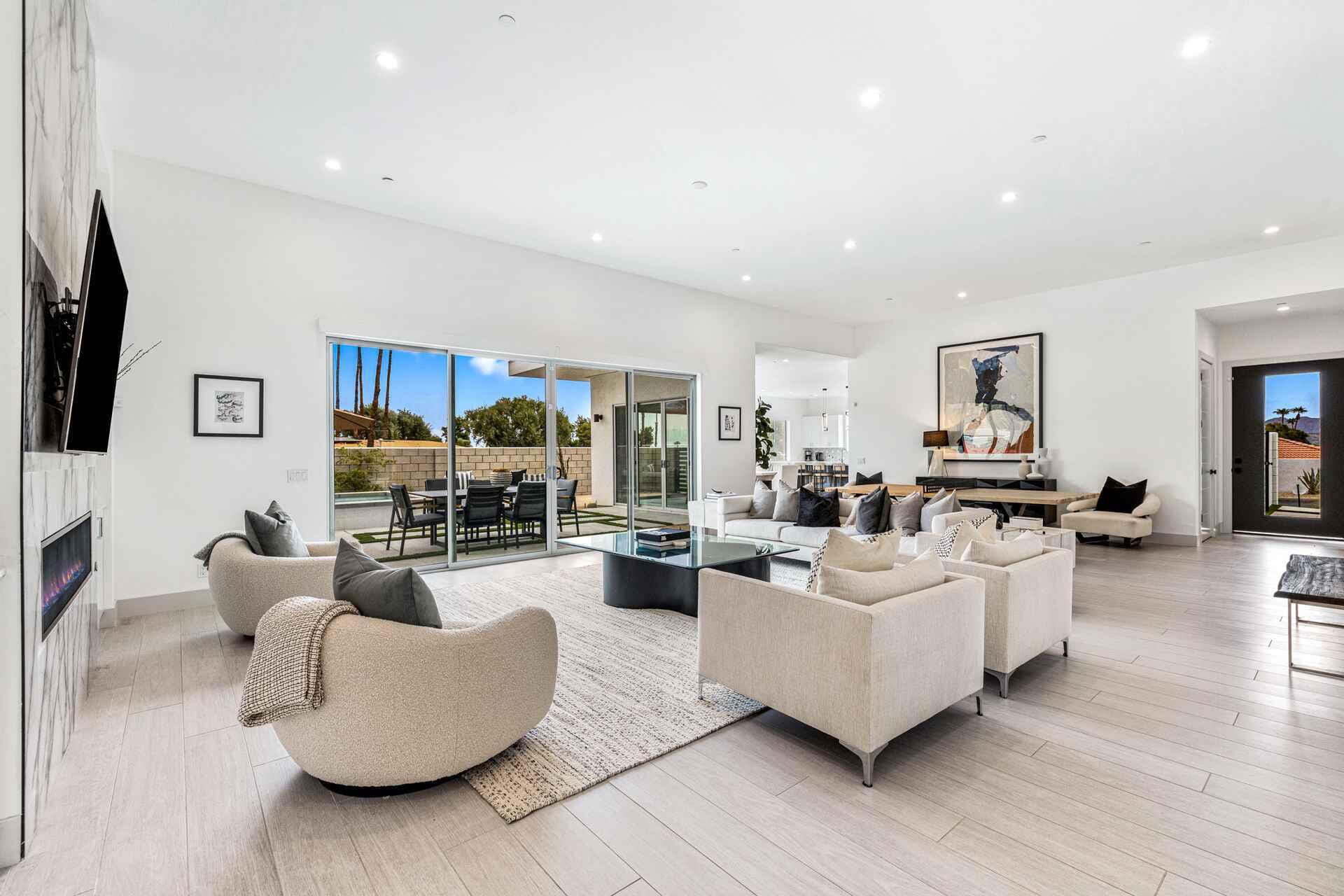 72985 Somera Road Palm Desert, CA 92260 - Photo 8 of 33 a living room with fireplace furniture and a flat screen tv