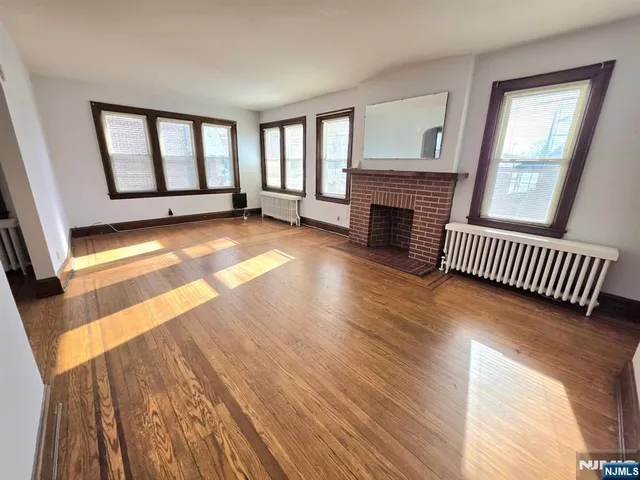 a view of livingroom with fireplace hardwood floor and window