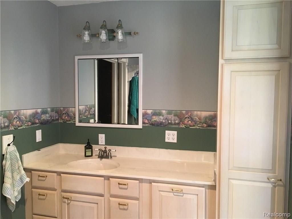 3175 Fisher Road Howell, MI 48855 - Photo 17 of 32 Mater bath with ample storage space and tile flooring.