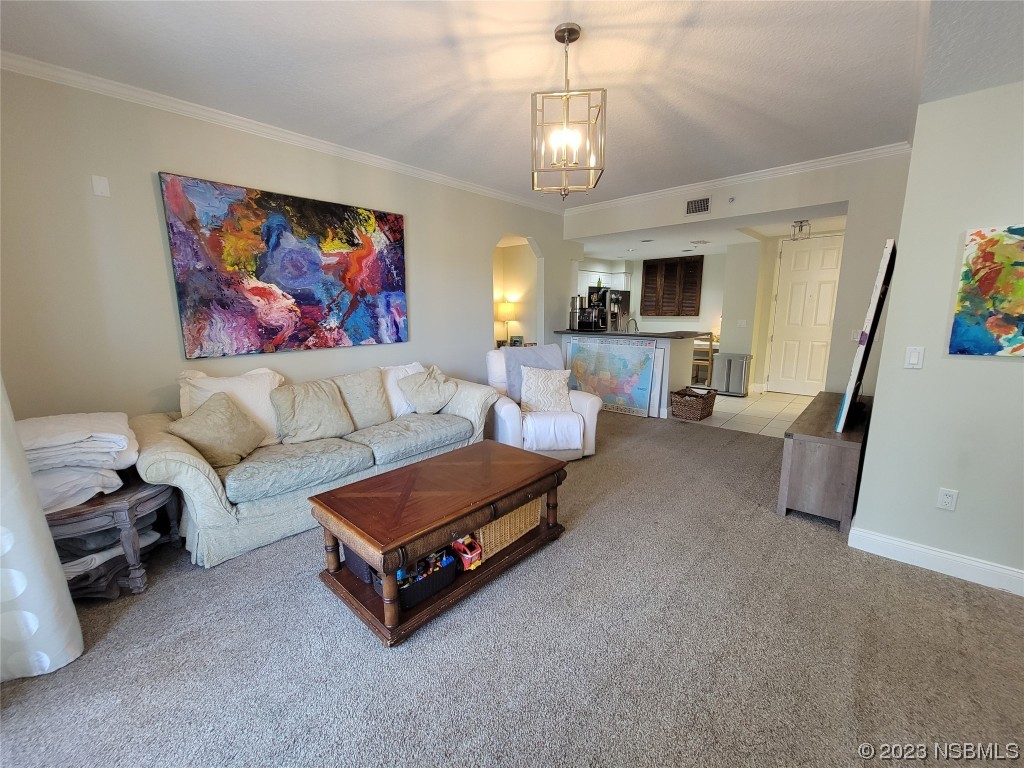 4623 Rivers Edge Village Lane, Unit 6204 Ponce Inlet, FL 32127 - Photo 15 of 62 a living room with furniture and a chandelier