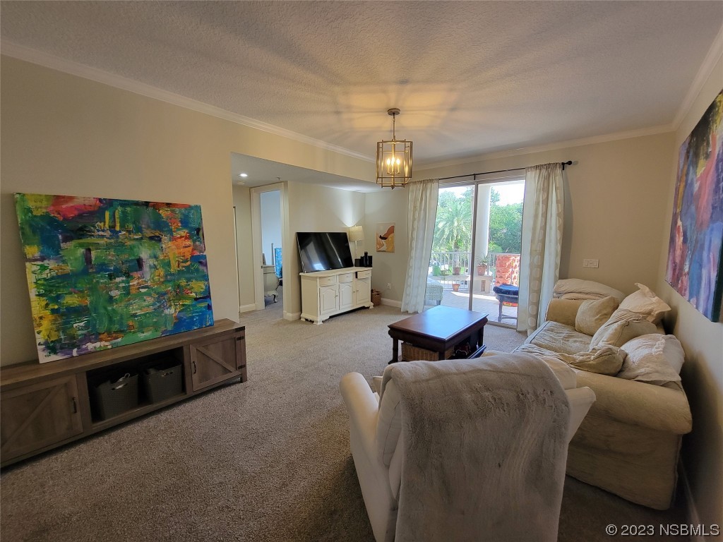 4623 Rivers Edge Village Lane, Unit 6204 Ponce Inlet, FL 32127 - Photo 16 of 62 a living room with furniture and a flat screen tv