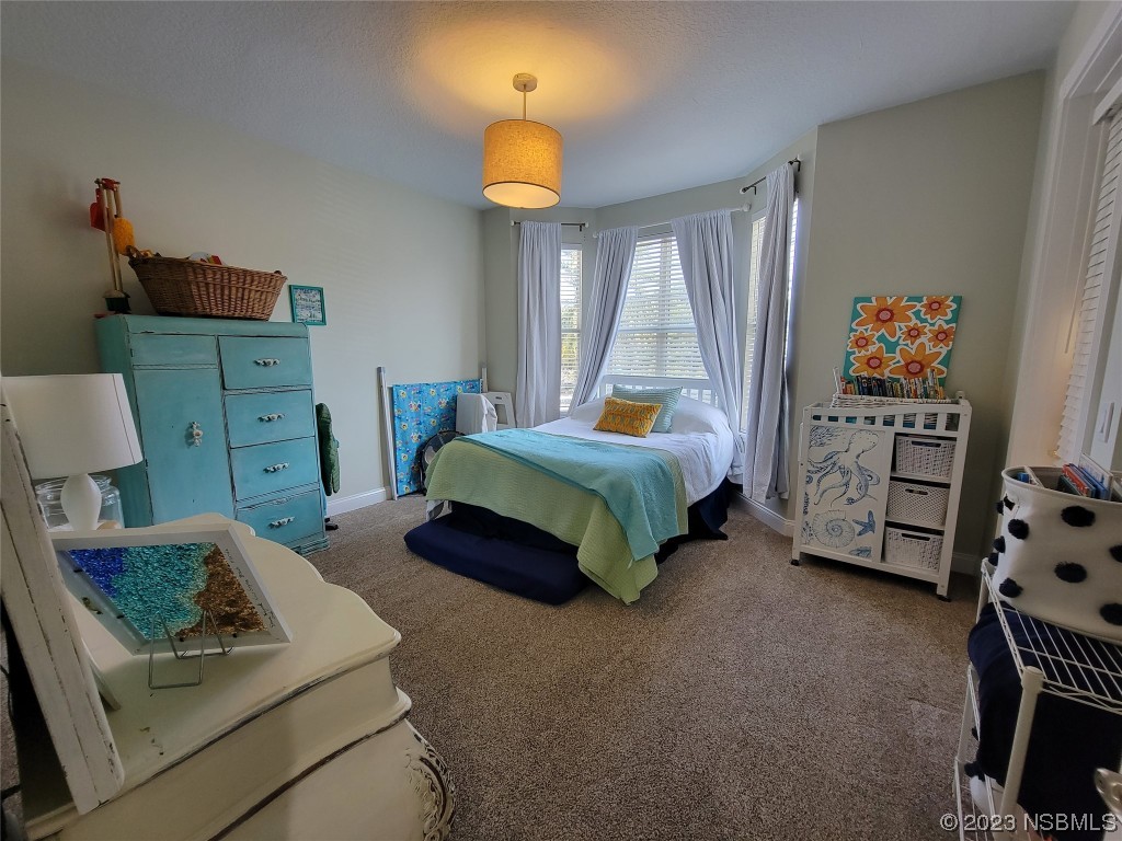 4623 Rivers Edge Village Lane, Unit 6204 Ponce Inlet, FL 32127 - Photo 17 of 62 a bedroom with furniture and a baby crib