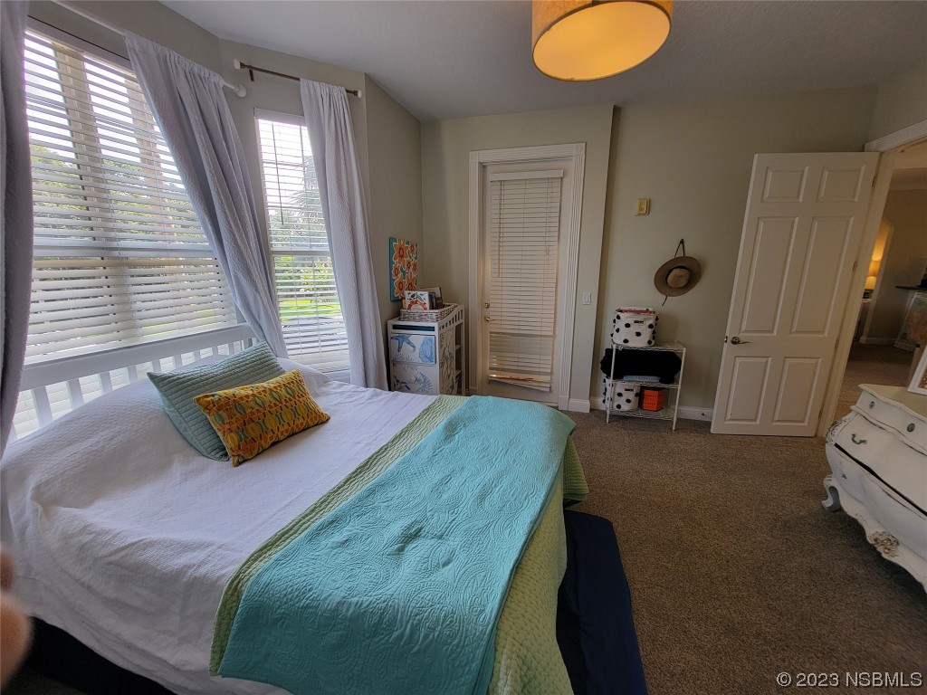 4623 Rivers Edge Village Lane, Unit 6204 Ponce Inlet, FL 32127 - Photo 18 of 62 a bedroom with a bed and window