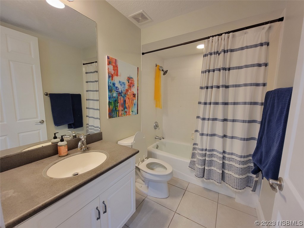 4623 Rivers Edge Village Lane, Unit 6204 Ponce Inlet, FL 32127 - Photo 19 of 62 a bathroom with a granite countertop sink toilet and shower