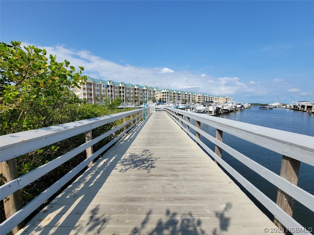 4623 Rivers Edge Village Lane, Unit 6204 Ponce Inlet, FL 32127 - Photo 22 of 62 a view of a balcony with wooden floor and city view