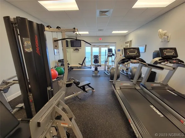 a kitchen with a sink a refrigerator and cabinets