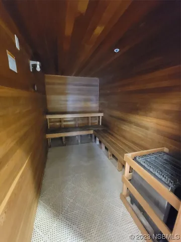 a view of a swimming pool with an outdoor seating and a forest