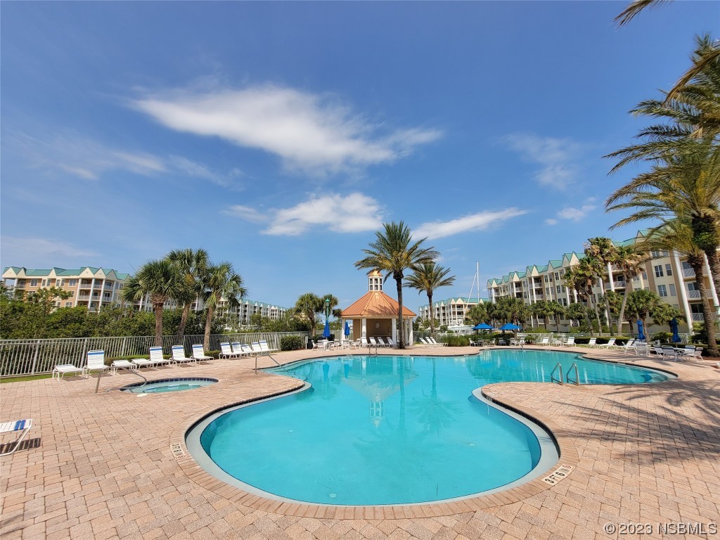 4623 Rivers Edge Village Lane, Unit 6204 Ponce Inlet, FL 32127 - Photo 3 of 62 a view of a swimming pool with outdoor seating
