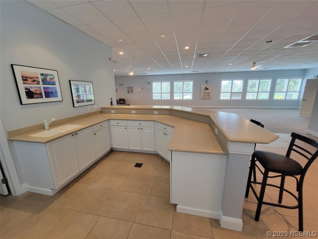 4623 Rivers Edge Village Lane, Unit 6204 Ponce Inlet, FL 32127 - Photo 31 of 62 a large white kitchen with a window